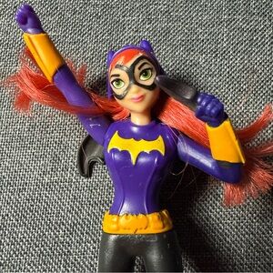 Dynamic Superheroine Action Figure with Purple and Yellow Outfit